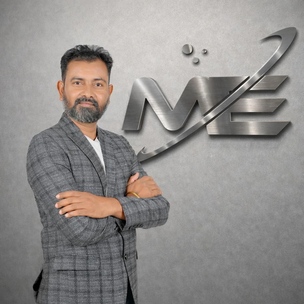 Ravi Patel, founder of Maan Enterprise, standing in front of the brand monogram.
