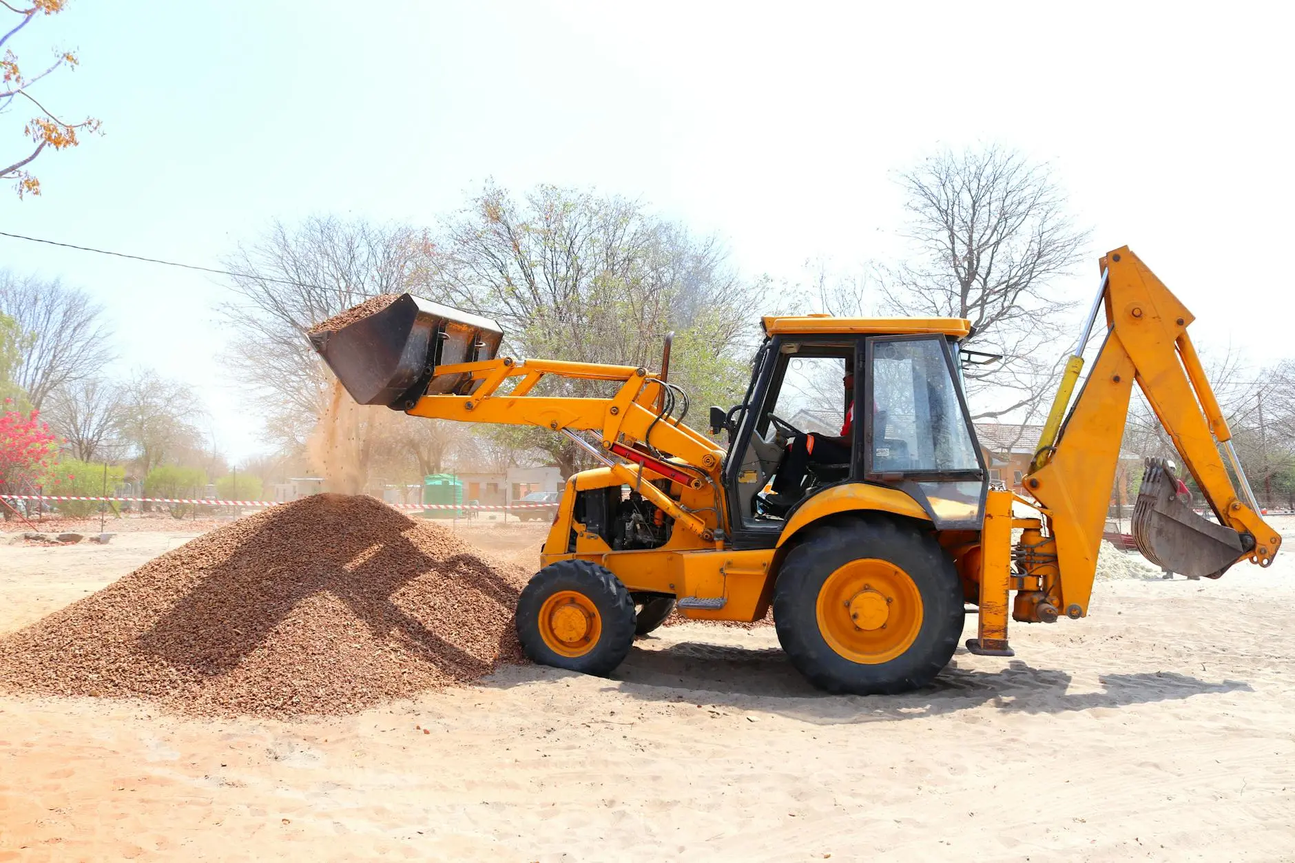 JCB loader filling a sand stockpile at the yard.